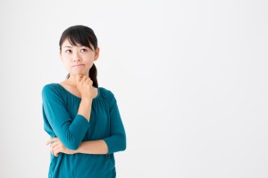 portrait of young asian woman thinking